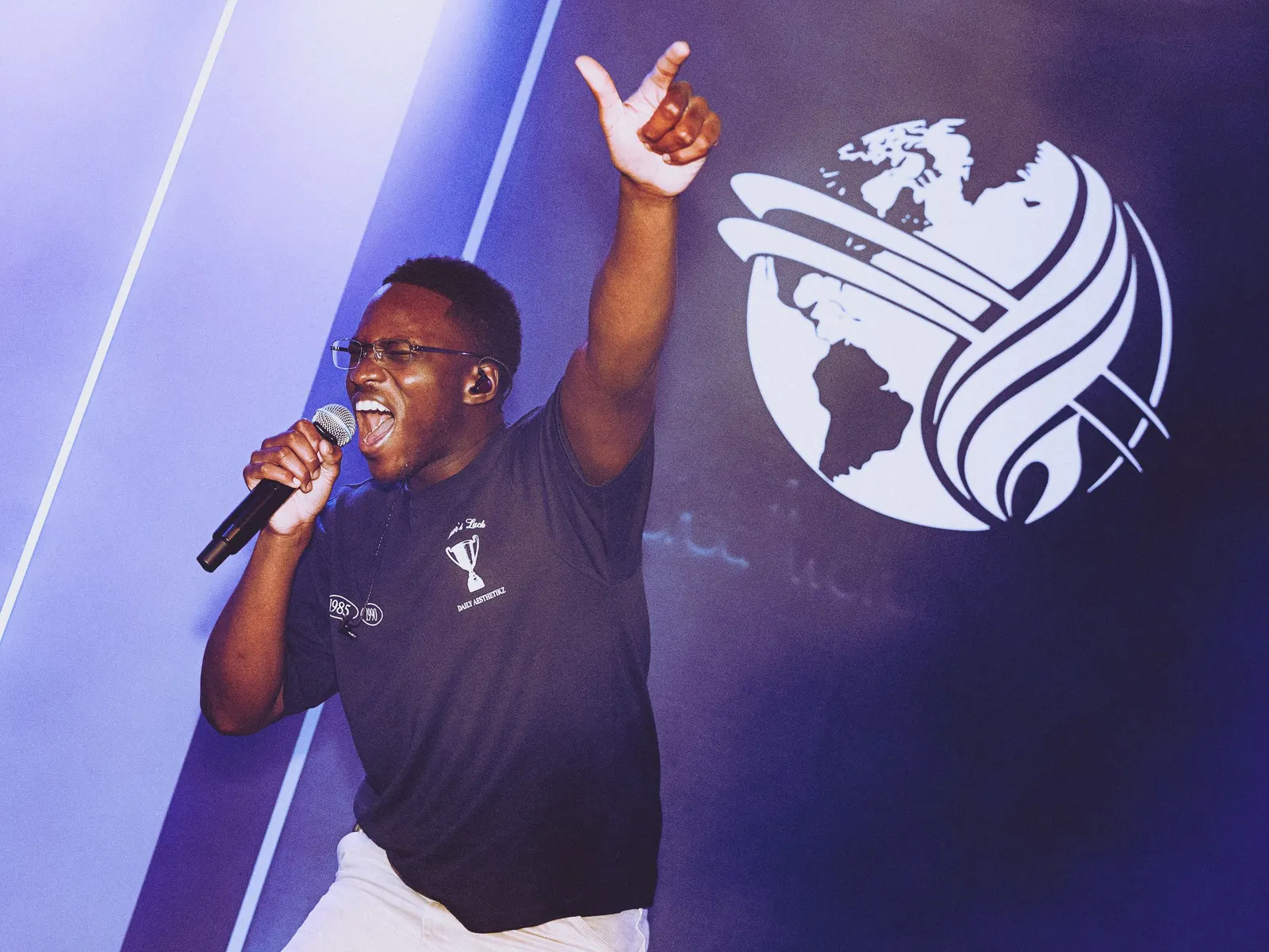 Een zanger zingt vol vreugde met zijn arm omhoog